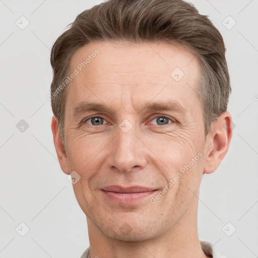 Joyful white adult male with short  brown hair and grey eyes