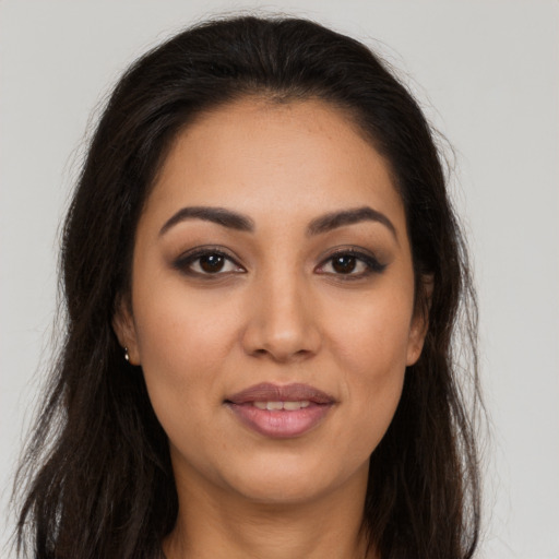 Joyful latino young-adult female with long  brown hair and brown eyes