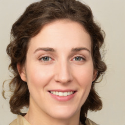 Joyful white young-adult female with medium  brown hair and green eyes