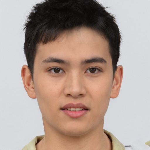 Joyful asian young-adult male with short  brown hair and brown eyes