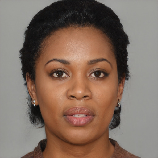 Joyful black young-adult female with short  brown hair and brown eyes