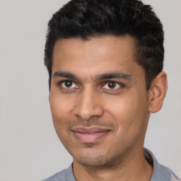 Joyful latino young-adult male with short  black hair and brown eyes