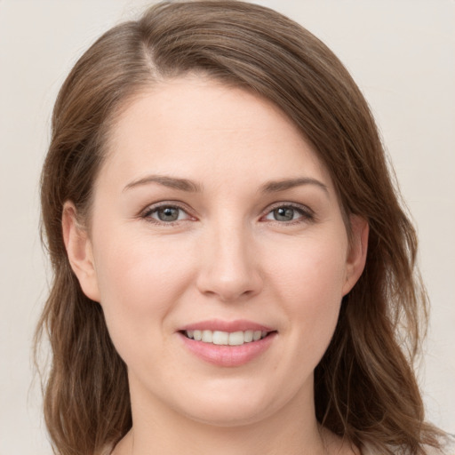 Joyful white young-adult female with medium  brown hair and grey eyes