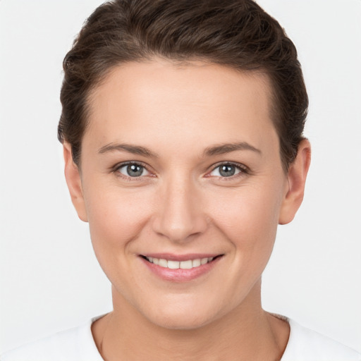 Joyful white young-adult female with short  brown hair and brown eyes