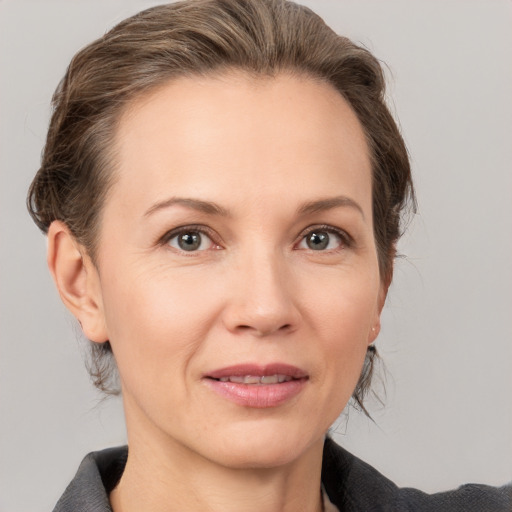 Joyful white adult female with medium  brown hair and grey eyes