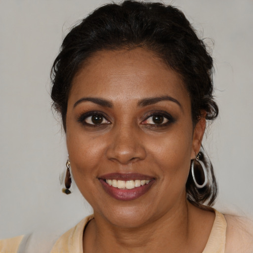 Joyful black young-adult female with medium  brown hair and brown eyes