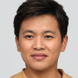 Joyful asian young-adult male with short  brown hair and brown eyes