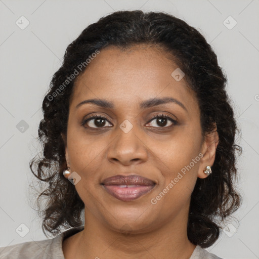 Joyful black adult female with medium  brown hair and brown eyes