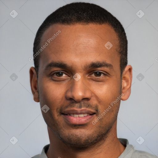 Joyful black young-adult male with short  black hair and brown eyes