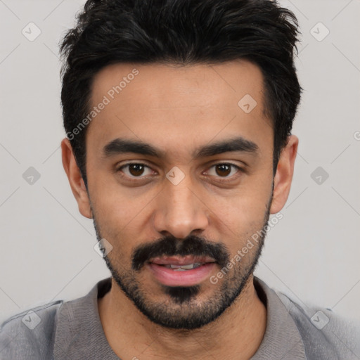 Joyful latino young-adult male with short  black hair and brown eyes