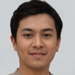 Joyful asian young-adult male with short  black hair and brown eyes