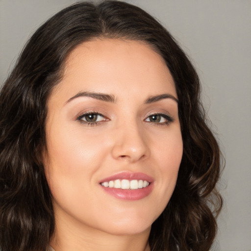 Joyful white young-adult female with long  brown hair and brown eyes