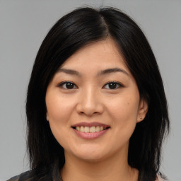 Joyful asian young-adult female with medium  brown hair and brown eyes