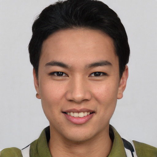 Joyful asian young-adult male with short  brown hair and brown eyes