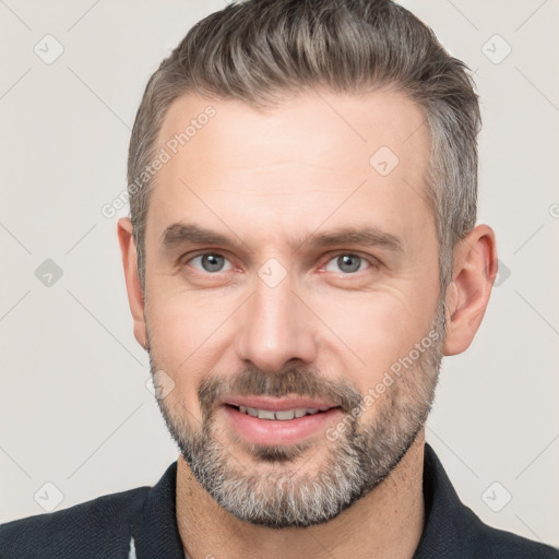 Joyful white adult male with short  brown hair and brown eyes