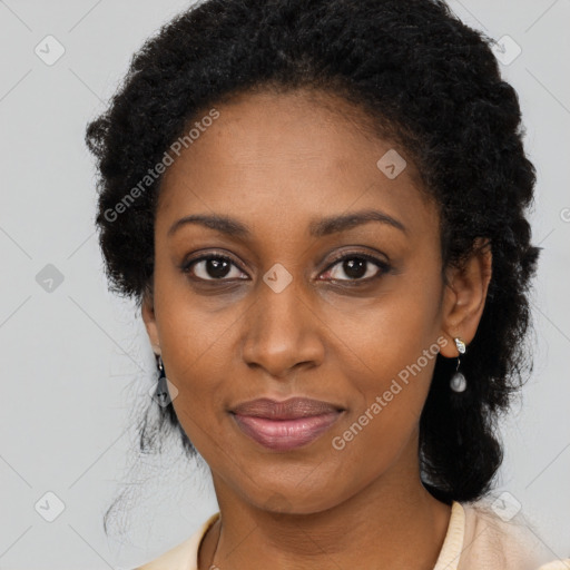 Joyful black young-adult female with long  black hair and brown eyes