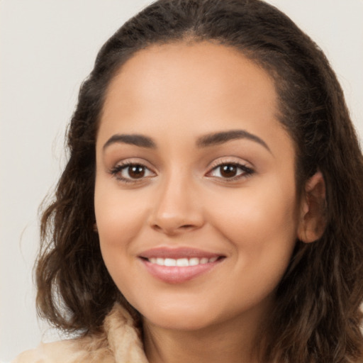 Joyful latino young-adult female with long  brown hair and brown eyes