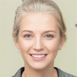 Joyful white young-adult female with medium  brown hair and blue eyes