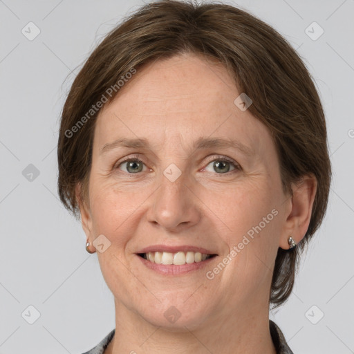 Joyful white adult female with medium  brown hair and grey eyes