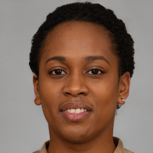 Joyful black young-adult female with short  brown hair and brown eyes