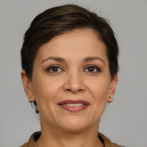Joyful white adult female with medium  brown hair and grey eyes