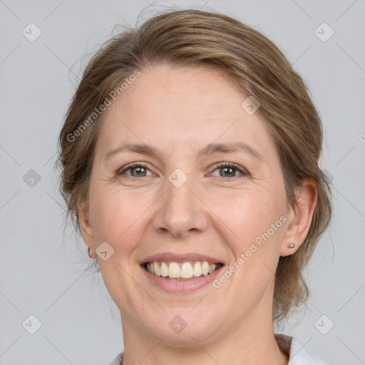 Joyful white adult female with medium  brown hair and grey eyes