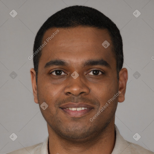 Joyful black young-adult male with short  black hair and brown eyes