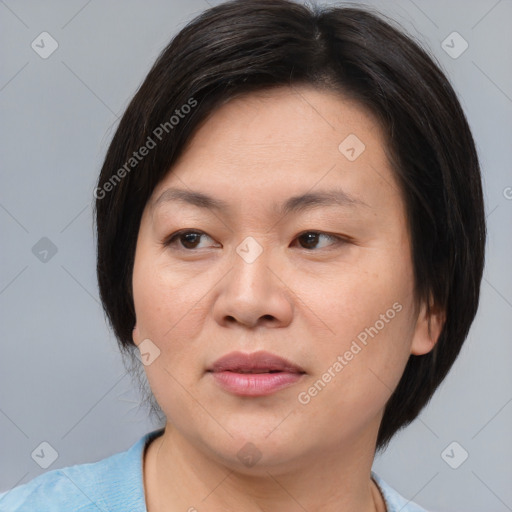 Joyful asian adult female with medium  brown hair and brown eyes