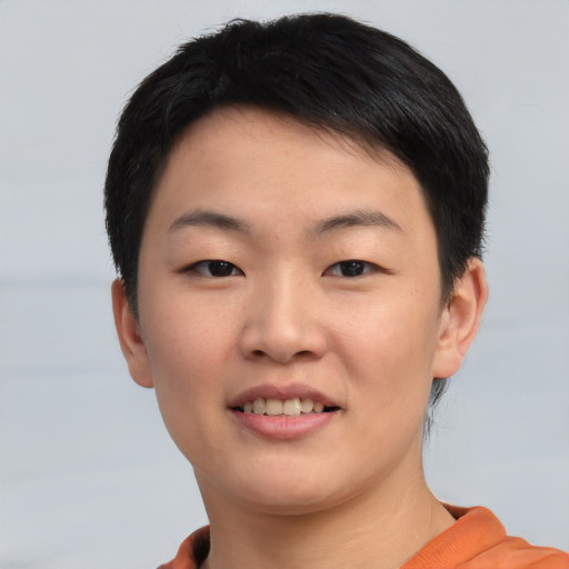 Joyful asian young-adult female with short  black hair and brown eyes