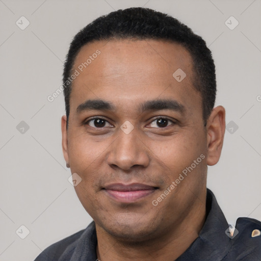 Joyful black young-adult male with short  black hair and brown eyes