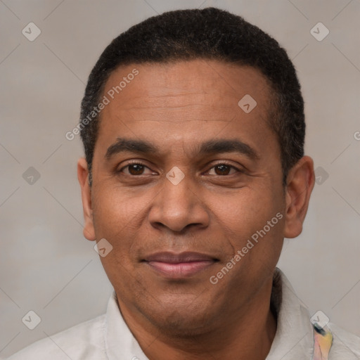 Joyful latino adult male with short  black hair and brown eyes