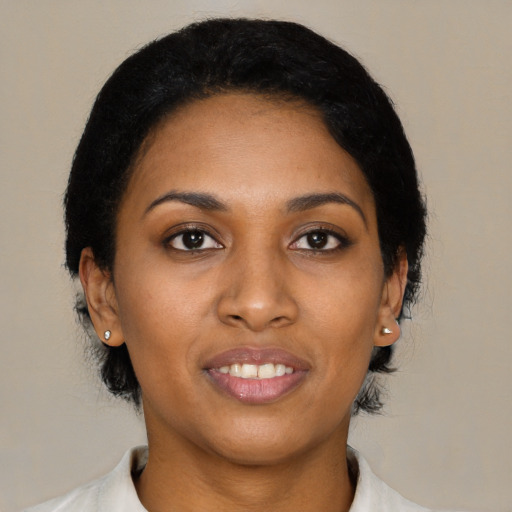 Joyful black young-adult female with medium  black hair and brown eyes