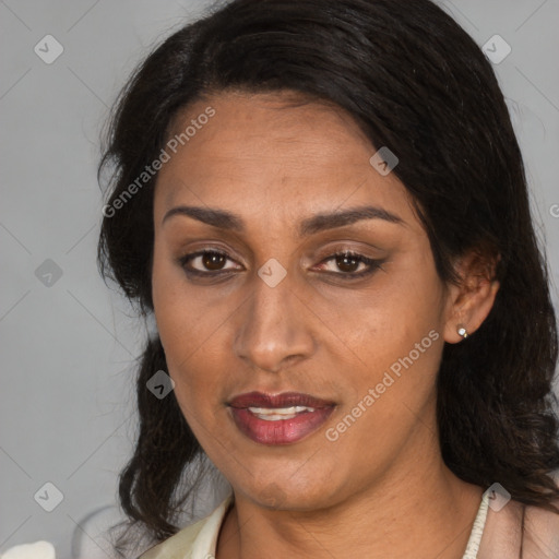 Joyful latino adult female with medium  brown hair and brown eyes