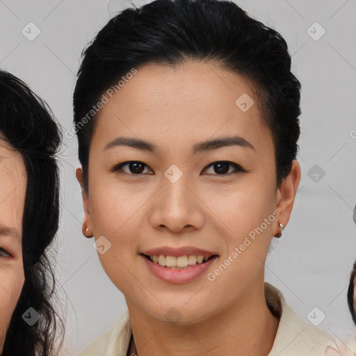 Joyful asian young-adult female with medium  black hair and brown eyes