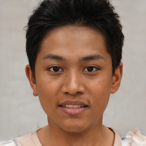 Joyful asian young-adult male with short  brown hair and brown eyes