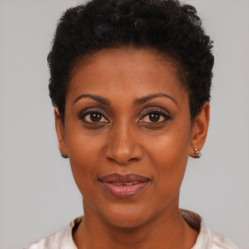 Joyful black young-adult female with short  black hair and brown eyes