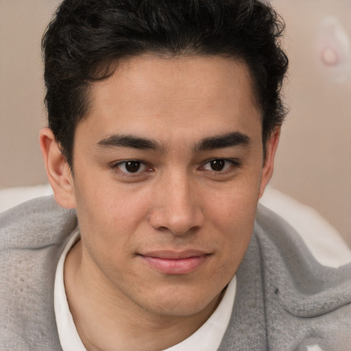 Joyful latino young-adult male with short  brown hair and brown eyes