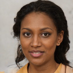 Joyful black young-adult female with medium  brown hair and brown eyes