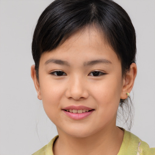 Joyful asian child female with short  brown hair and brown eyes