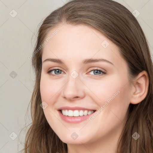 Joyful white young-adult female with long  brown hair and blue eyes