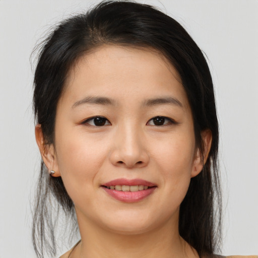 Joyful asian young-adult female with medium  brown hair and brown eyes