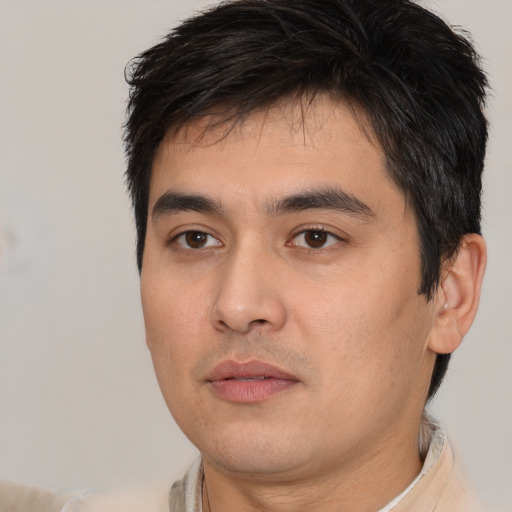 Joyful white young-adult male with short  black hair and brown eyes