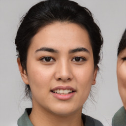 Joyful asian young-adult female with medium  brown hair and brown eyes