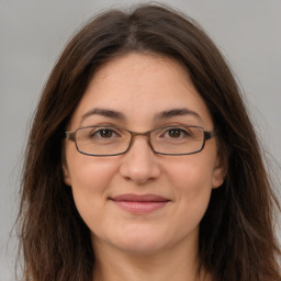 Joyful white adult female with long  brown hair and brown eyes