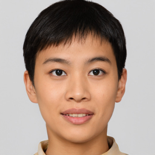 Joyful asian young-adult male with short  brown hair and brown eyes