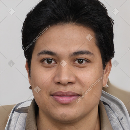 Joyful latino young-adult male with short  brown hair and brown eyes