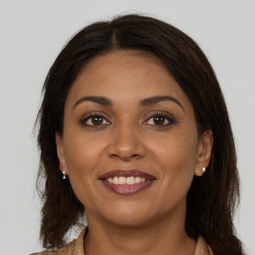 Joyful latino young-adult female with long  brown hair and brown eyes