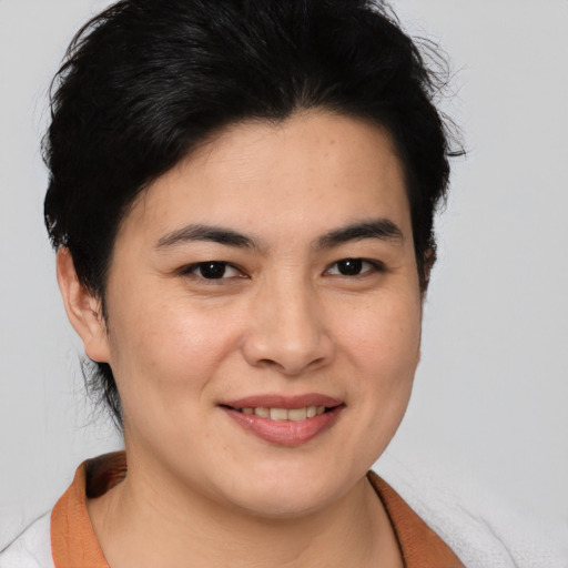 Joyful white young-adult female with medium  black hair and brown eyes
