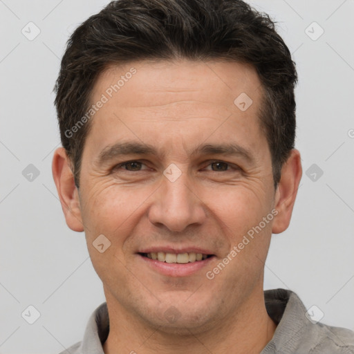 Joyful white adult male with short  brown hair and brown eyes