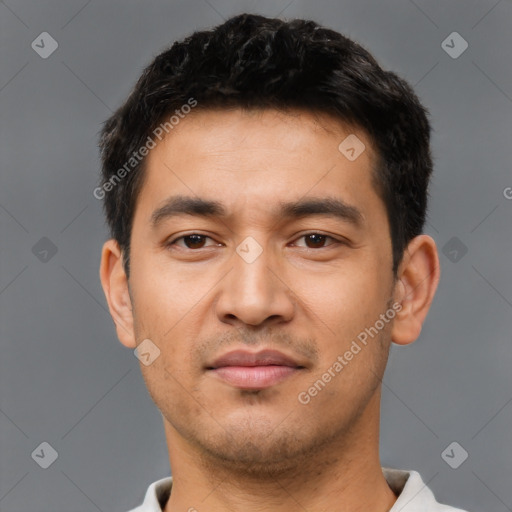 Joyful asian young-adult male with short  black hair and brown eyes